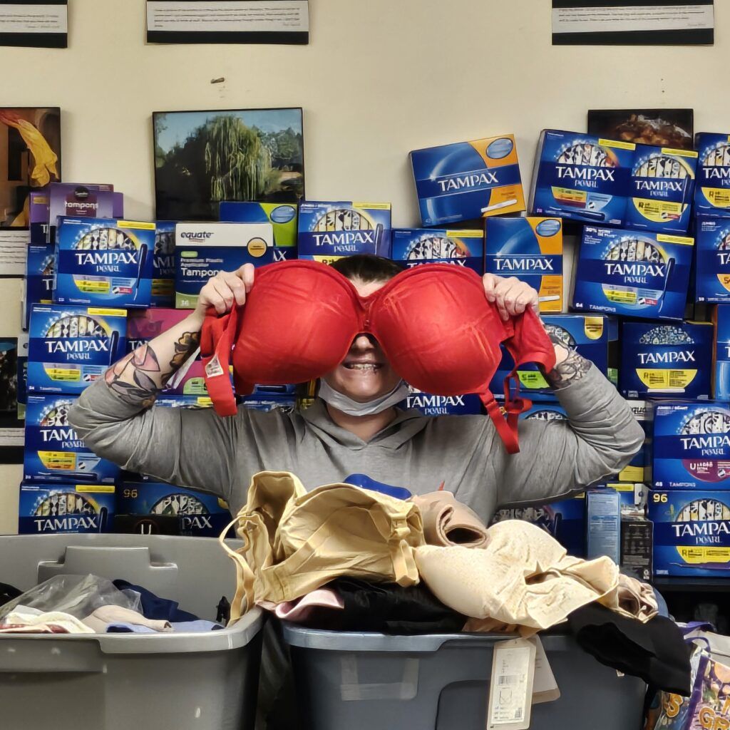 woman holds bra in front of face