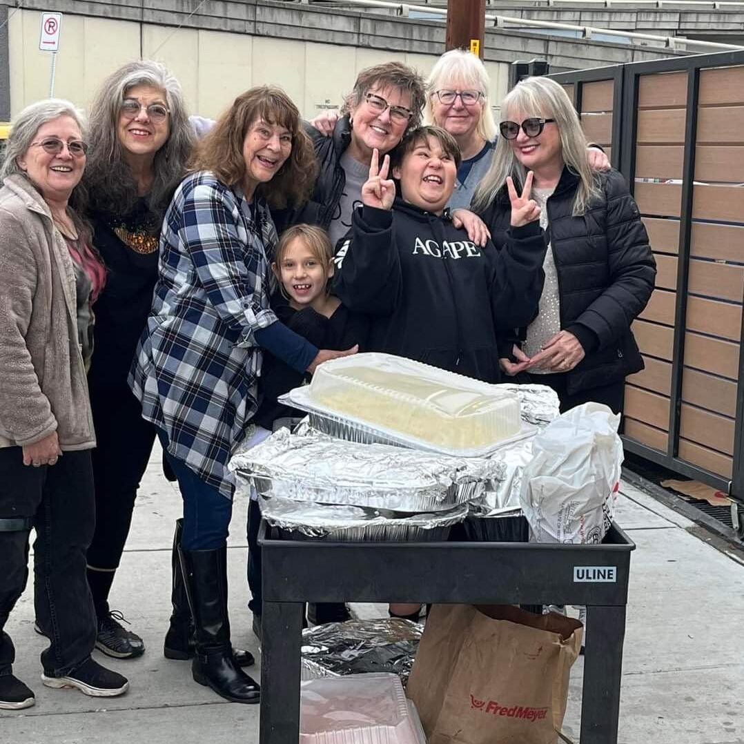 people hugging around a cart